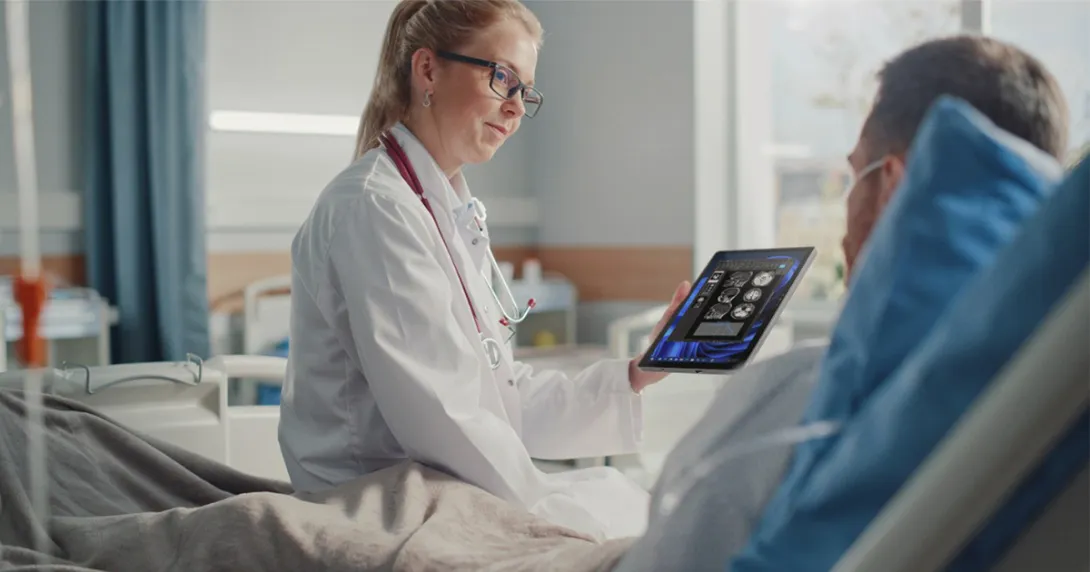 Healthcare worker showing tablet to patient