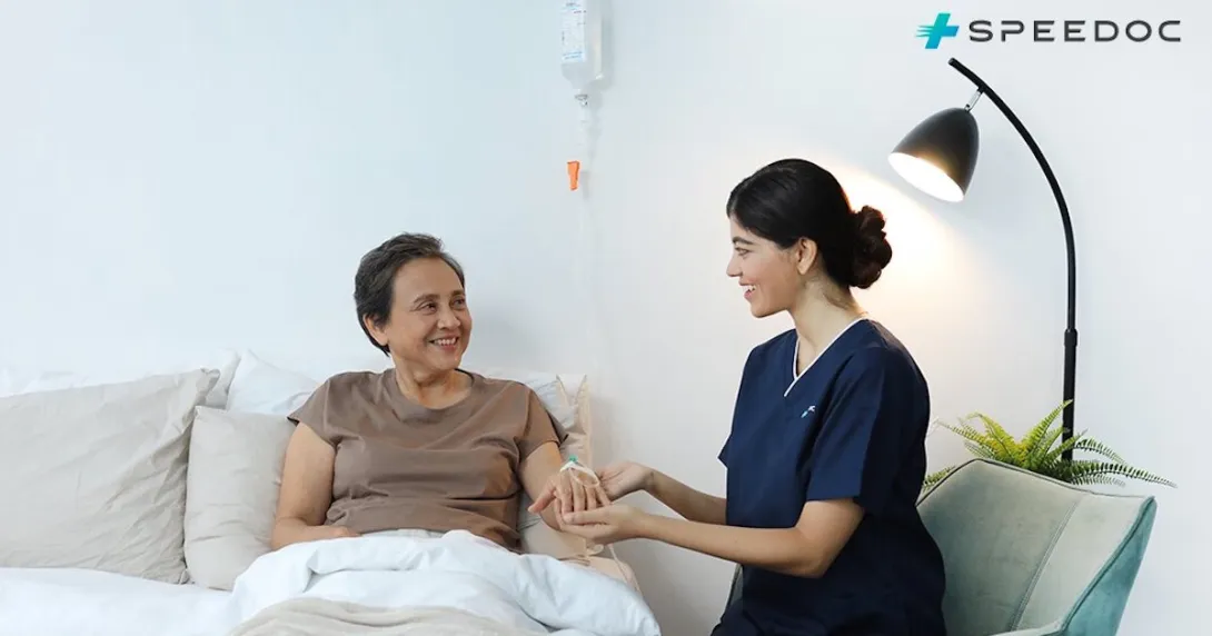 A nurse attending to a patient at home