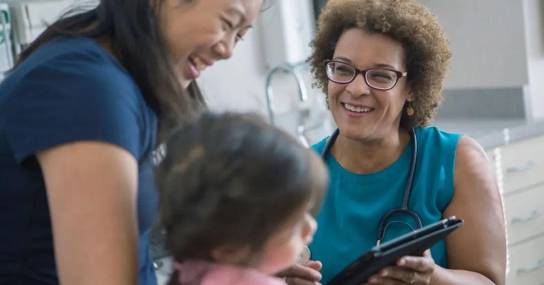 Healthcare worker talking to patient and child