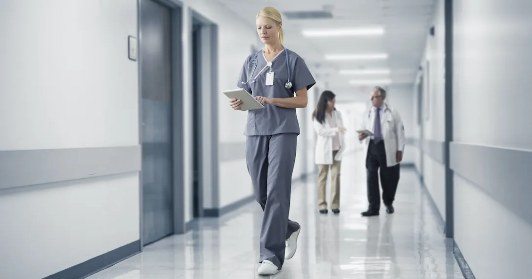 A doctor checking a patient's record on their digital tablet