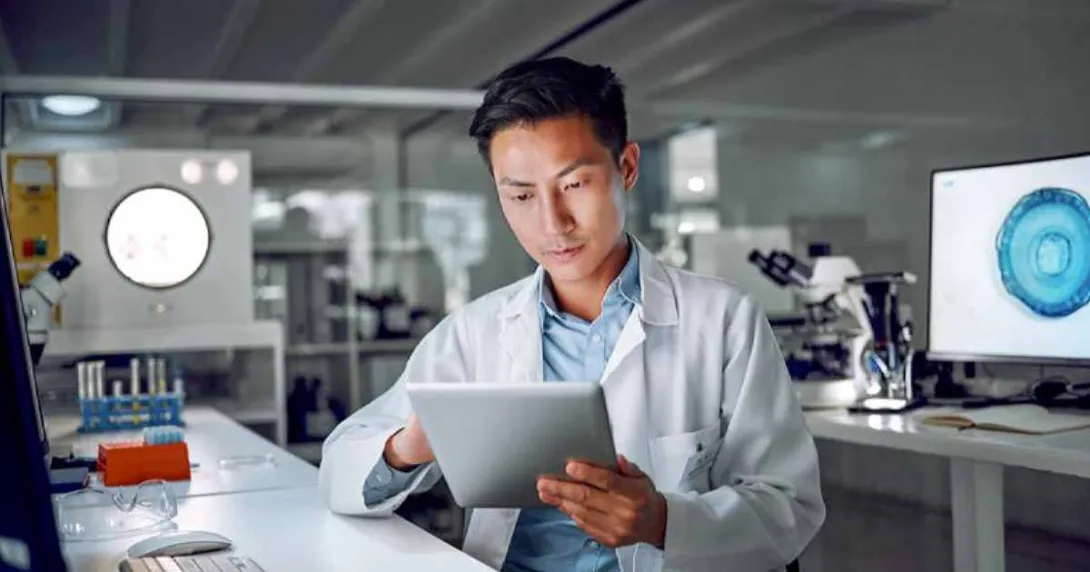 Doctor in lab looking at tablet