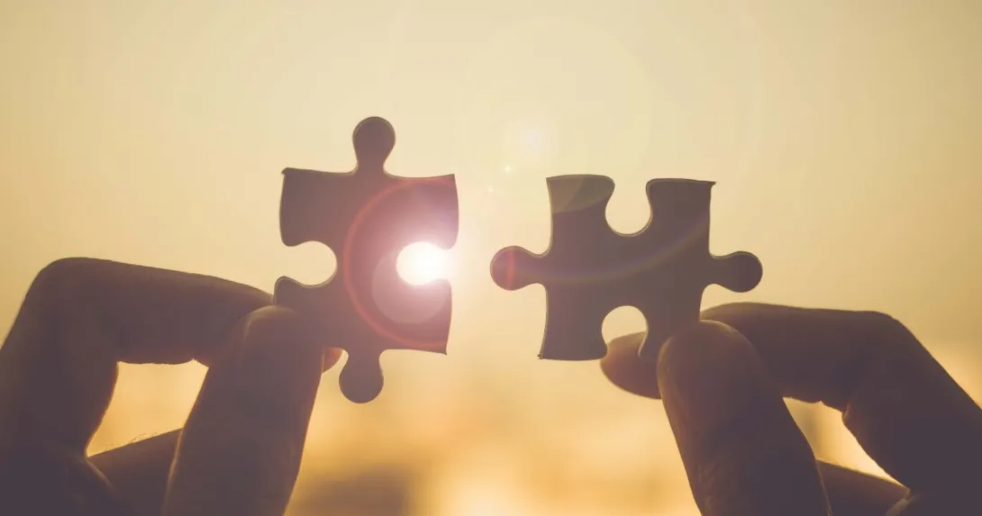 Puzzle pieces fitting together, showing connection and success