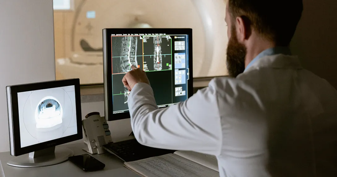 Radiologist looks at an MRI on screen