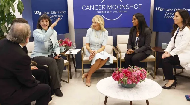 Dr. Monica Bertagnolli speaks as, from left, Dr. Alan Ashworth, Dr. Paola Bentancur, First Lady Dr. Jill Biden, medical student Kami Pullakhandam and Dr. Rita Mukhtar