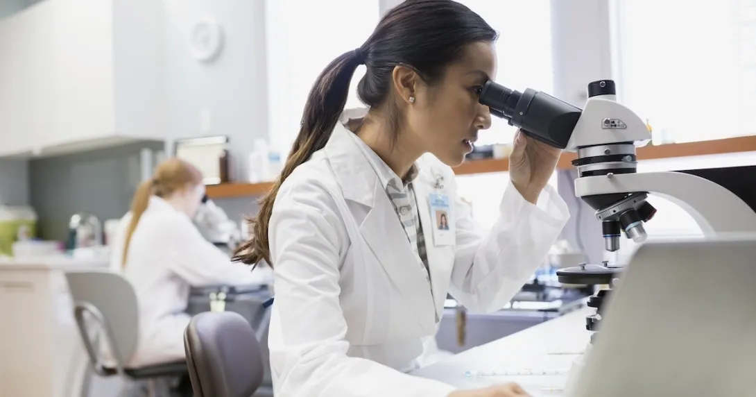 Lab worker using a microscope