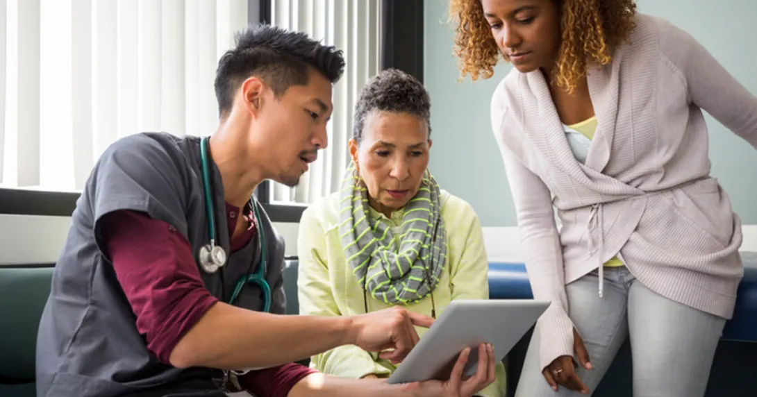 Doctor with patient and caregiver
