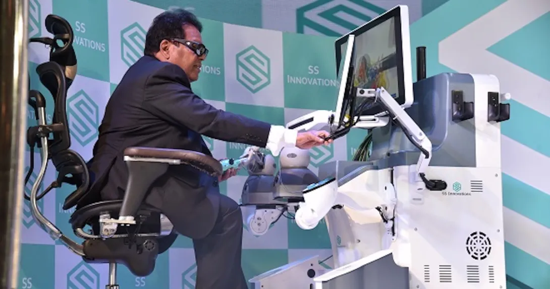 A doctor demonstrating the use of a robot-assisted surgery system