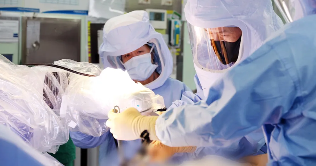 Surgeons operating using robotic technology