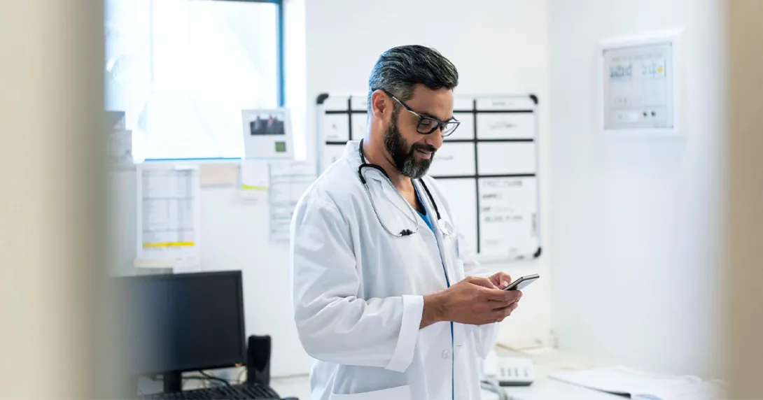 Doctor looking at smartphone