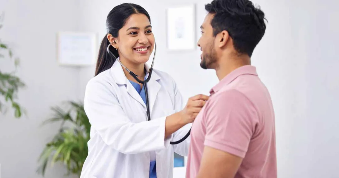 Doctor using stethoscope on patient