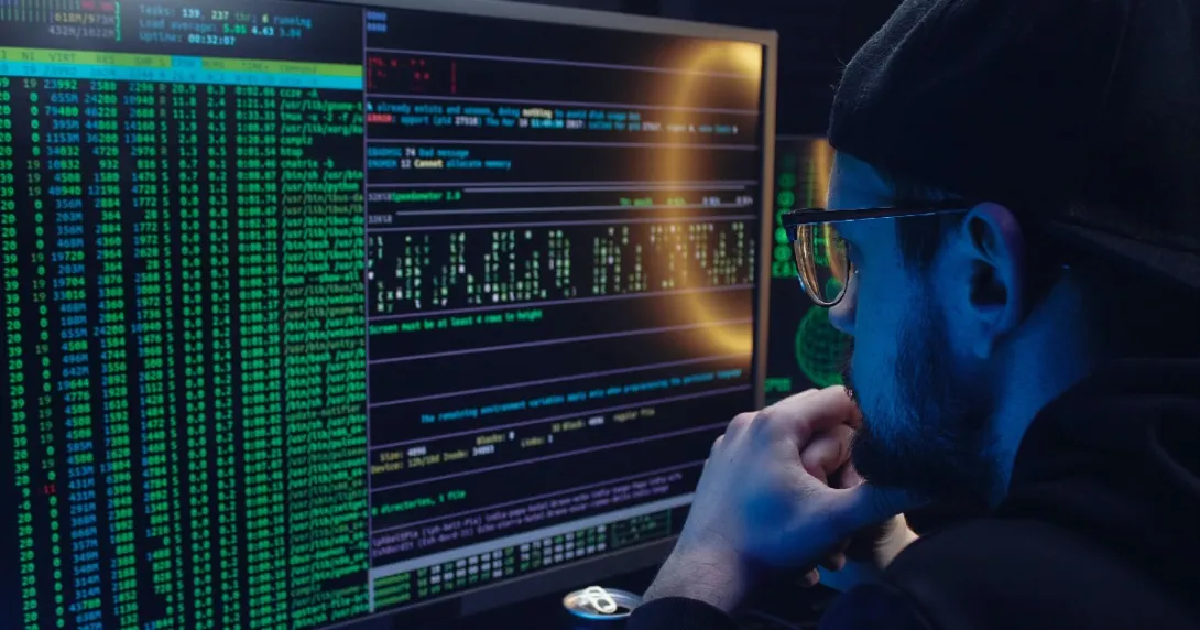 Hacker looking at screens