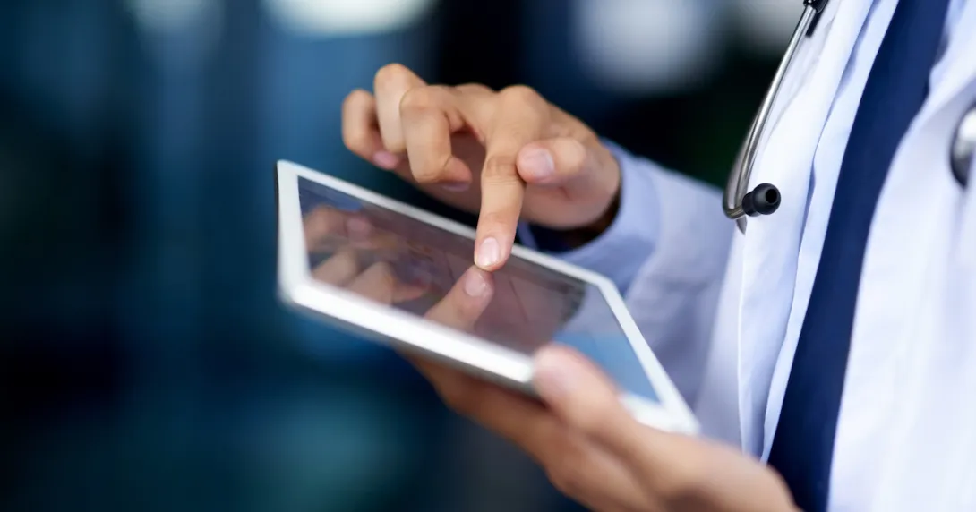 healthcare professional using a tablet