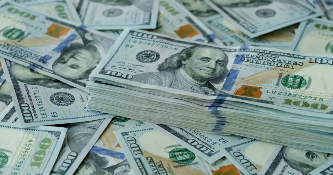 Stack of $100 U.S. dollars on loose bills