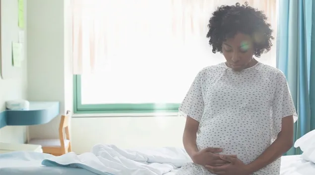 Pregnant person on hospital bed
