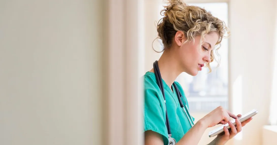 Clinician reviews medical notes on a tablet