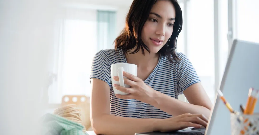 Woman on laptop engages in telehealth coaching