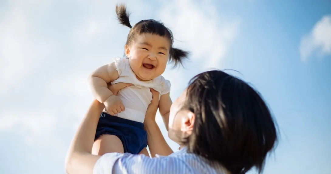 Person holding child in the air
