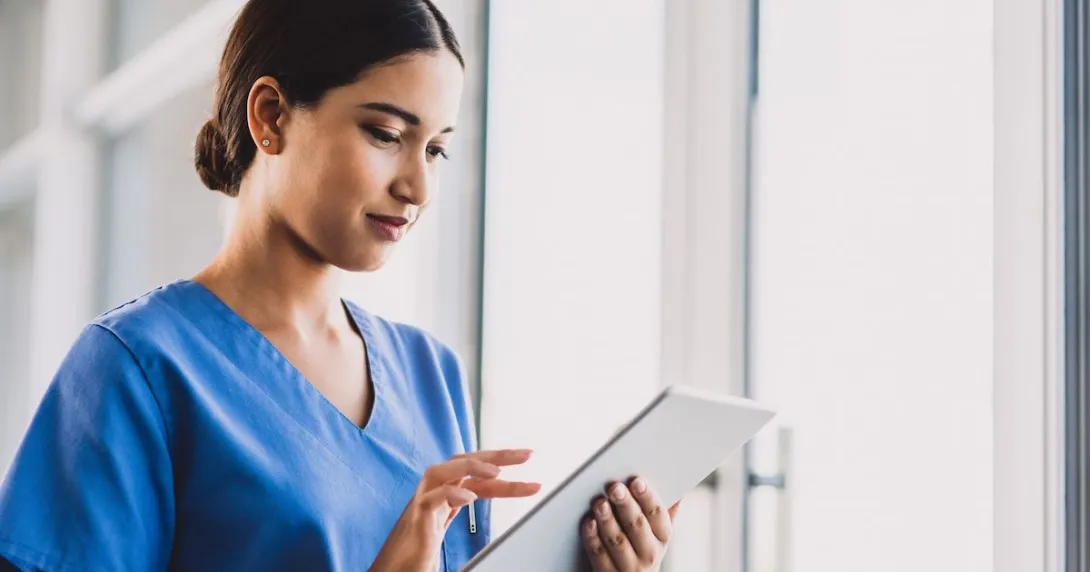 A clinician enters documentation on a tablet.