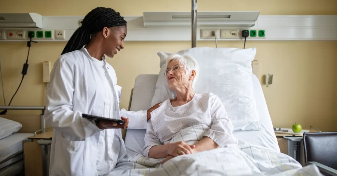 A doctor interacting with a patient in bed