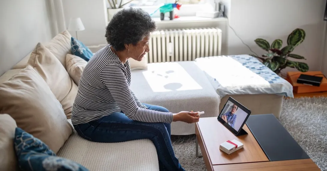 A patient in a virtual consultation with a doctor using a digital tablet