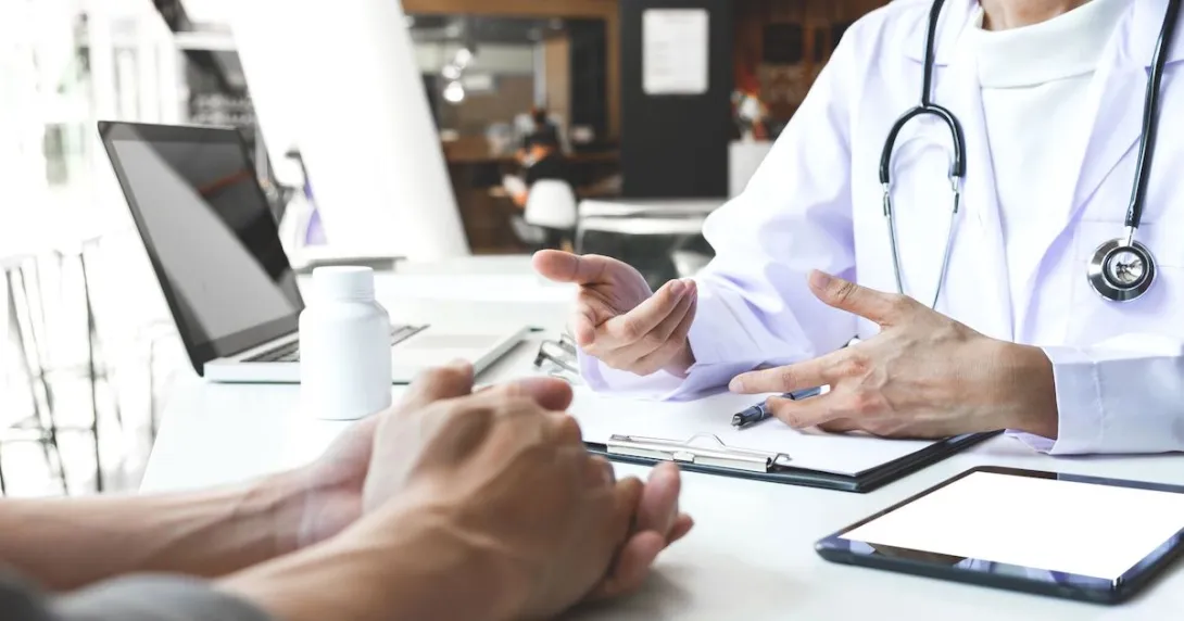 A doctor and patient in an in-person consultation