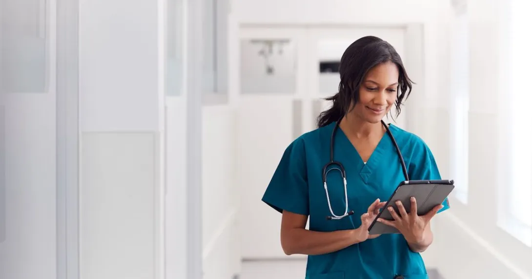 A doctor checking a patient record on their digital tablet.