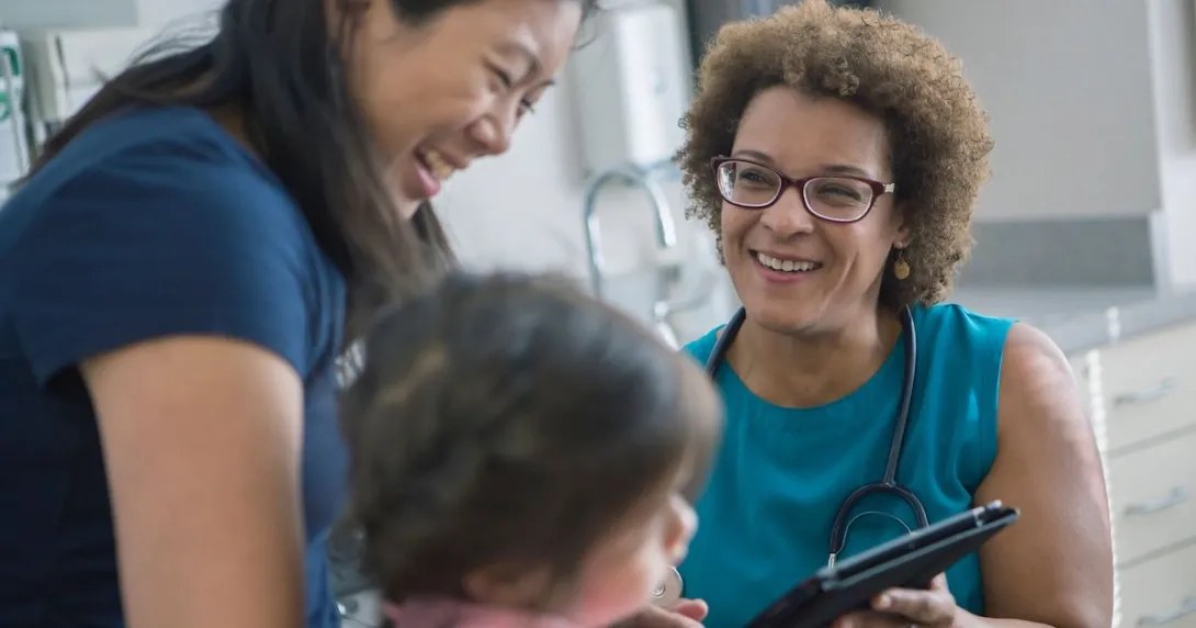 pediatrician with child and caregiver
