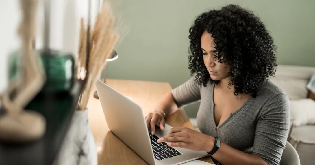 Healthcare patient at home desk with laptop